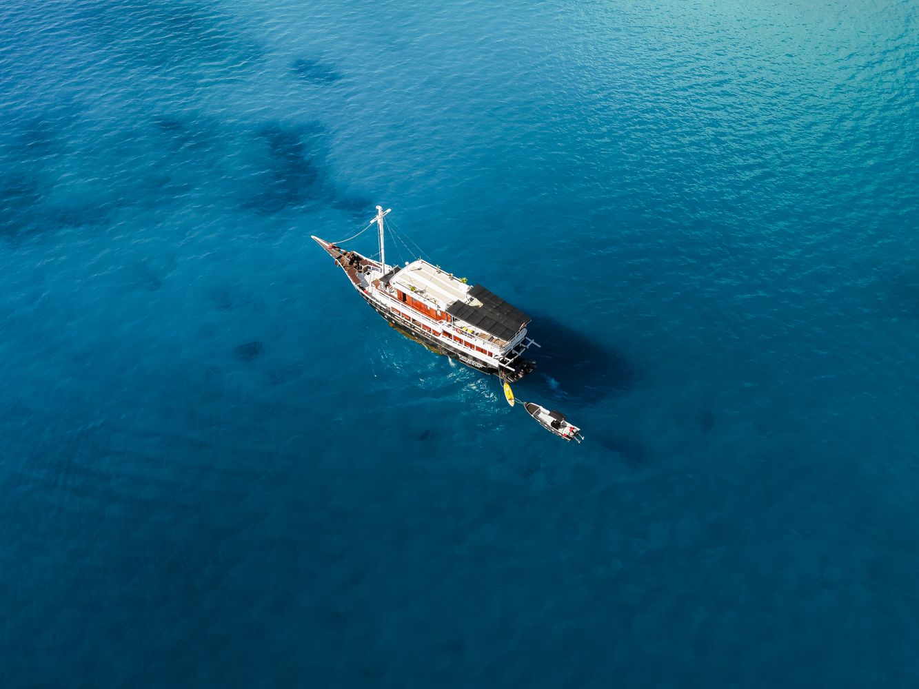 Aerial view of Maki anchored in clear water